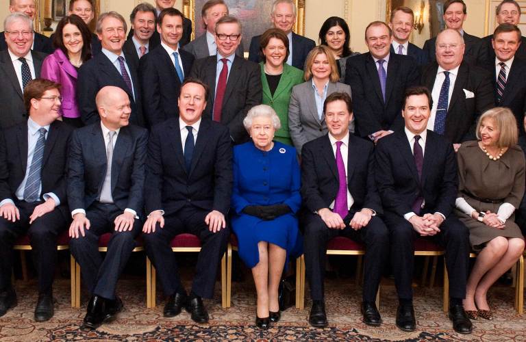 TOPSHOTS  Britain's Queen Elizabeth II (C) sits flanked by British Prime Minister David Cameron (L) and Deputy Prime Minister Nick Clegg (R) as members of the Cabinet pose for a family picture at No 10 Downing Street in central London December 18, 2012. Queen Elizabeth II attended her first-ever cabinet meeting on Tuesday to mark her diamond jubilee, the only monarch to do so since 1781.The 86-year-old sovereign sat in as an observer on the meeting and received a gift from the Cabinet to celebrate her 60 years on the throne. AFP PHOTO / POOL / JEREMY SELWYN